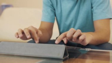 Akıllı telefon cevap, konuşurken tablet kullanarak Divan mavi tişörtlü rahatsız adam