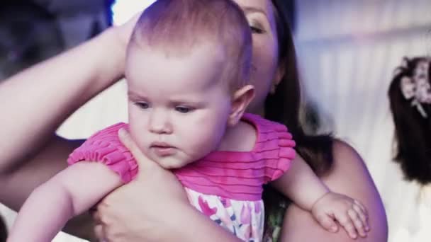 Mother hold on hands cute baby girl in restaurant on celebration event. Happy — Stock Video