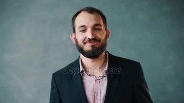 Ceket ve palming, gülümseyen çizgili gömlekli yüz gevşek dişleriyle sakallı adam