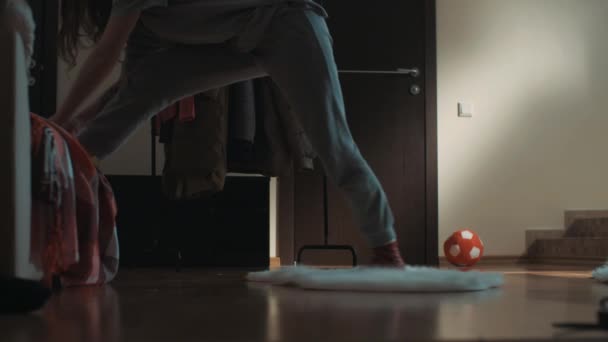 Divertida mujer flexible en la sala de estar accidentalmente hace divisiones y cae al suelo — Vídeo de stock