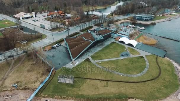 Aerial view of modern architect building in city suburbs with loan yard — Stock Video