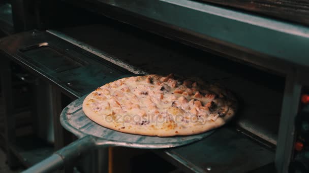 Cooking chef take pizza out oven using metal peel tool — Stock Video