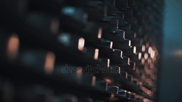 Shelves with stacks of metal disks at semi dark storage room — Stock Video