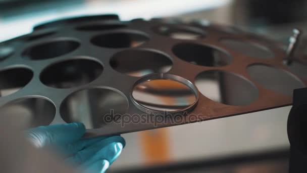 Engineer hand in rubber glove rotate metal device with lens in hole — Stock Video