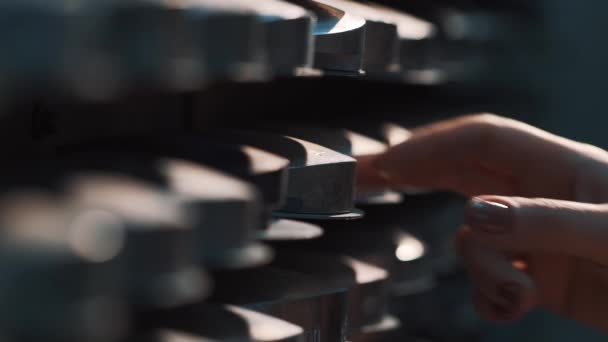 Woman hand take metal disc of shelves stack at facility storage room — Stock Video