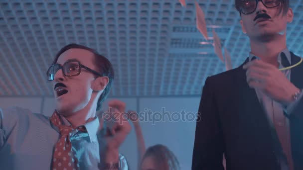 Dorky office workers in huge glasses fake mustaches dancing at party with girls — Stock Video