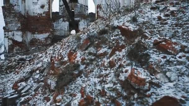 Old abandoned orthodoxal cathedral building, piles of bricks covered in snow — Stock Video