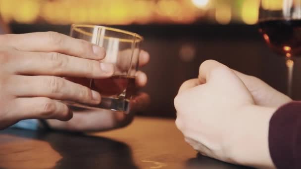 Hands of couple on date having conversation over alcohol drinks — Stock Video