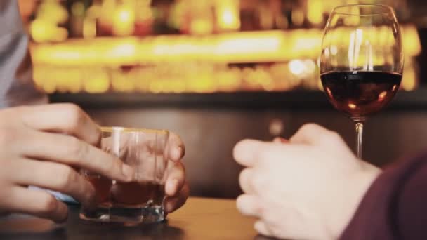 Hands of couple on date talking over alcohol drinks — Stock Video