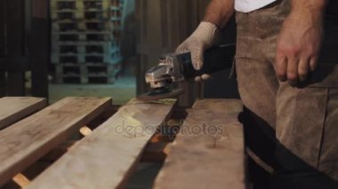 Woodworker adam ahşap Komiteler yapısını düzeltmek için açılı taşlama makinesi kullanın