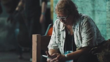 Saint Petersburg, Rusya Federasyonu - 20 Mayıs 2017: Kalabalık konveksiyon içinde oturan gözlüklü kadın arıyor orta yaşlı