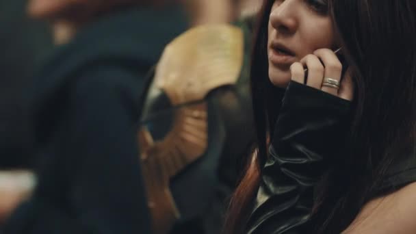 SAINT PETERSBURG, RUSSIA - MAY 20, 2017: Brunette girl in black vest talking on phone at cosplay festival — Stock Video