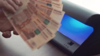 İşadamı el beş bin Rublesi banknot uv ışık dedektörü üzerinde kontrol