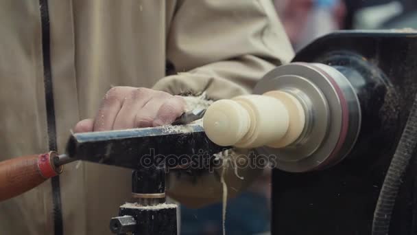 Slow motion joiner hands cutting door handle out wood piece spinning on machine — Stock Video