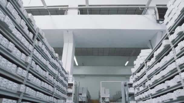 Bright repository shelves full of white boxes with numbers markings — Stock Video