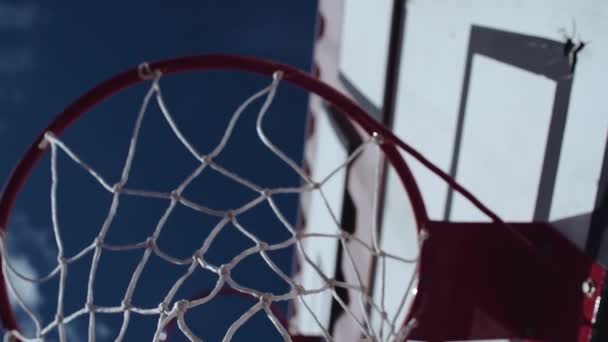 Basketball metal rings outside in front of blue sky — Stock Video