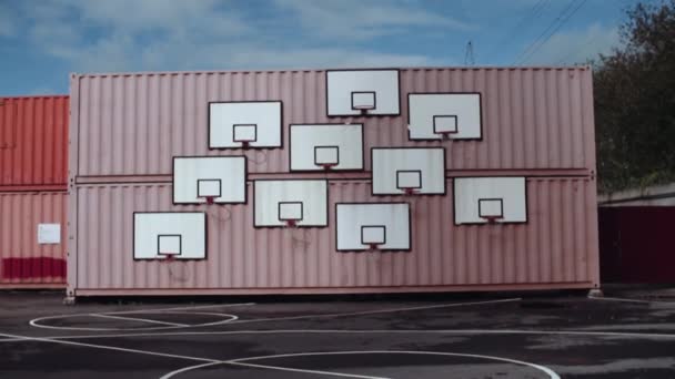 Cargo containers covered with basketball rings at sports or art area — Stock Video