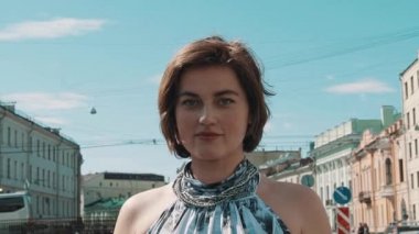 Riverside, eski şehir merkezinde, poz benekli elbiseli genç ve güzel kız