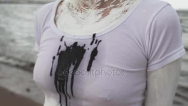 Black spit marks on activist artist female shirt at sea shore — Stock Video