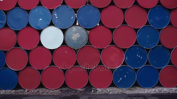 Young blonde woman walks in front of stack of colorful barrels — Stock Video