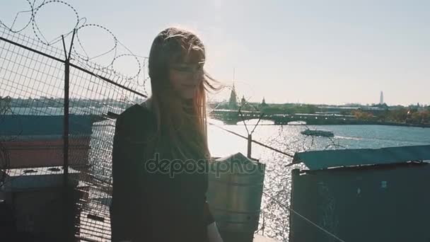 Preciosa joven en vestido negro en la azotea con vista panorámica del río de la ciudad — Vídeos de Stock