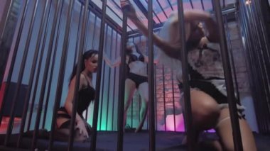 Gece kulübü kafeste siyah iç çamaşırı seksi genç kadın baştan çıkarıcı dansları