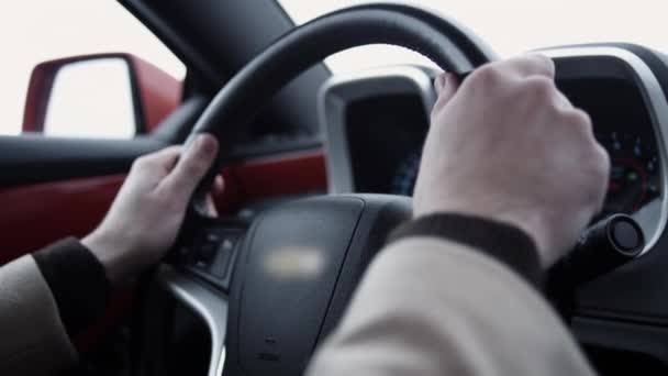 Man hands on steering wheel driving expensive car on bright day — Stock Video