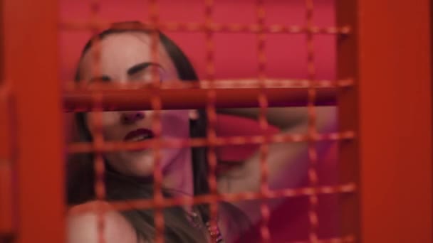 Young sexy woman in red cage and leather gloves seductive dancing — Stock Video