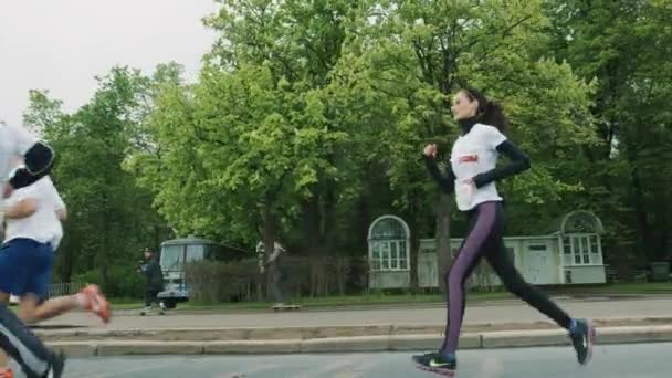 Delgado chica bonita en ropa deportiva corriendo maratón con multitud — Vídeos de Stock