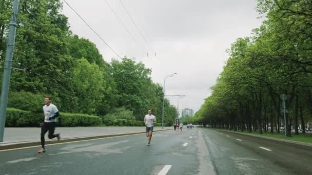 Pessoas alegres e esportivas participam da maratona correndo em asph — Vídeo de Stock