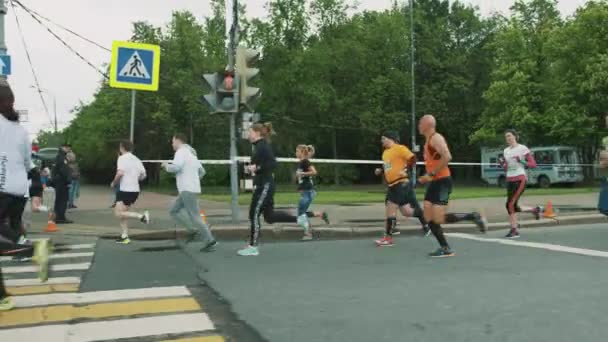 Mass of different athletes running marathon on city road — Stock Video