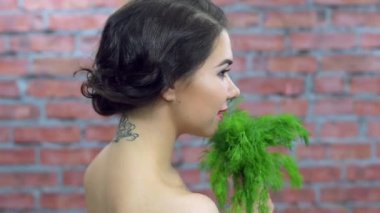 Yeşil maydanoz ile kameraya poz sutyen gülümsüyor, genç kız. Döküm. Makyaj