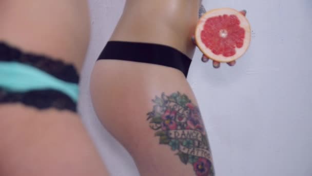Sexy booty of girl with garnet, turning booty girl with carrot in underwear. — Stock Video