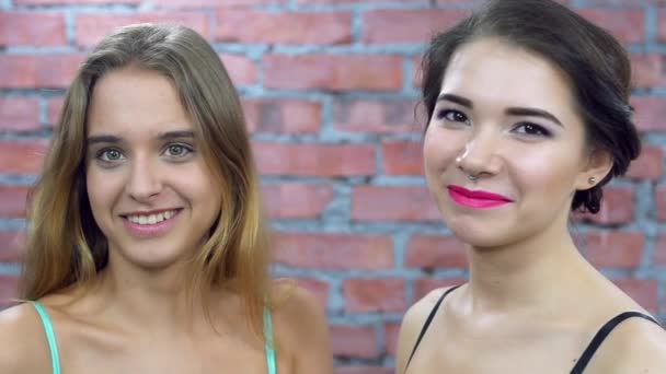 Two attractive young girls in bra smiles on camera. Green parsley. Casting. — Stock Video