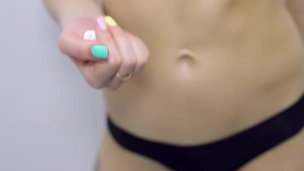 Woman hand hold three white dice, shake it. Close up. Bright nails. Slim body. — Stock Video