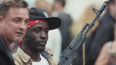 Saint Petersburg, Rusya - 24 Haziran 2017: Sıkılmış genç siyah adam gangster kıyafeti insanlar kalabalık Festivali ile poz