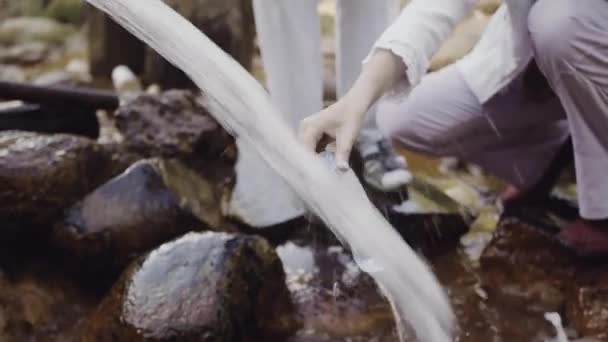 Donna mani bottiglia di riempimento da sorgente di acqua dolce nei boschi — Video Stock