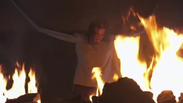 Crazy man with sleeves tied to ceiling struggling in burning abandoned building — Stock Video