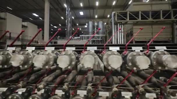 Inside view of huge modern factory full of tubes. pipelines and other equipment — Stock Video