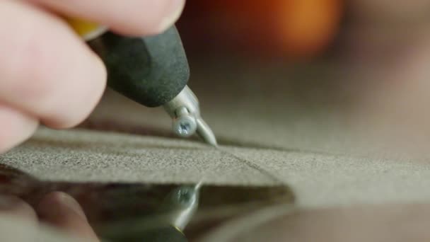 Workers hand is carefully sandblasting writing on dark surface of granite block — Stock Video