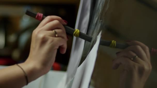 Closeup view of females hand holding metallic tool and hitting granite with it — Stock Video