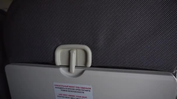 Young guys hand is unlocking and locking grey air plane tray table. — Stock Video