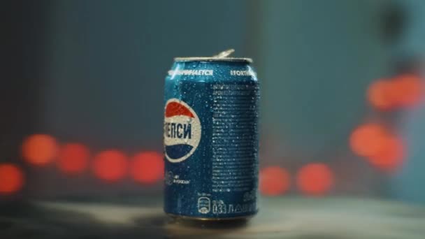 SAINT PETERSBURG, RUSSIA - NOVEMBER 23, 2019: Camera rotates around blue PEPSI can put on table with artificial foggy smoke — Stockvideo