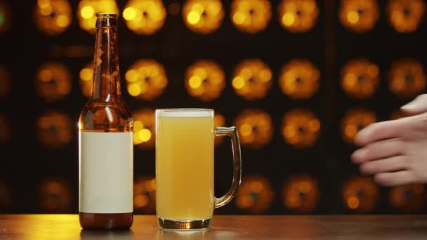 Mans Hand Takes Glass Beer Standing Desk Next Bottle Bokeh — Stock Video