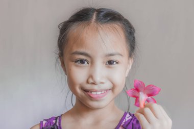 Mutlu sevimli Asya çocukları kapatın. Çiçek ile mutlu neşeli gülümseyen çocuklar portresi.