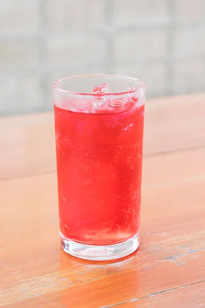 Red soda in the glass on wooden background — Stock Photo, Image