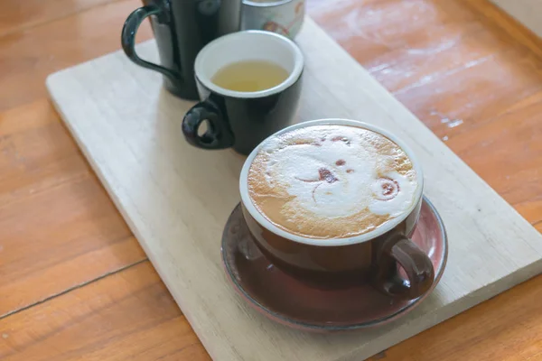 Zbliżenie białe filiżanka kawy z niedźwiedzia ręcznie rysowane na górnym, Kawa latte na drewniane. — Zdjęcie stockowe