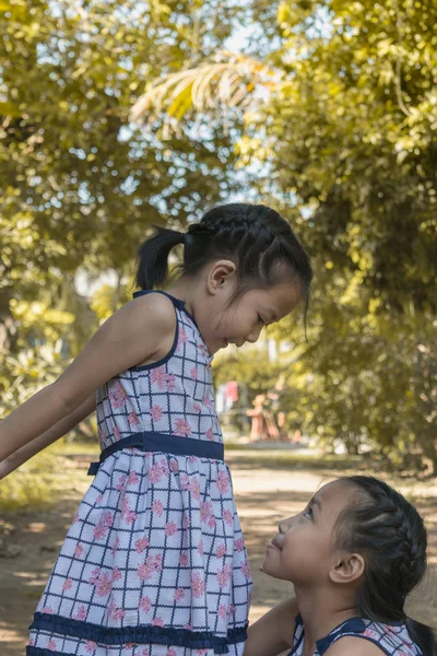 Adorable happy couple kids help each other in the park. Happy kids concept.