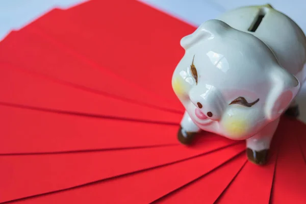 Piggy bank with Pile Red envelope isolate white background.