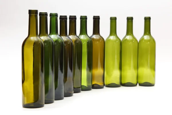 Empty bottles standing in a row on white background — Stock Photo, Image